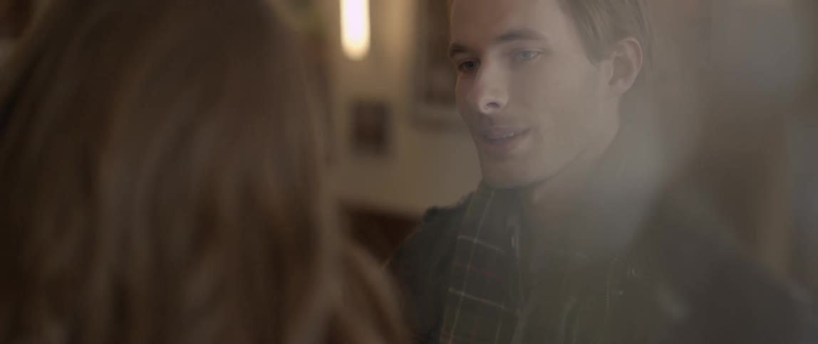 Man smiles at woman in a restaurant
