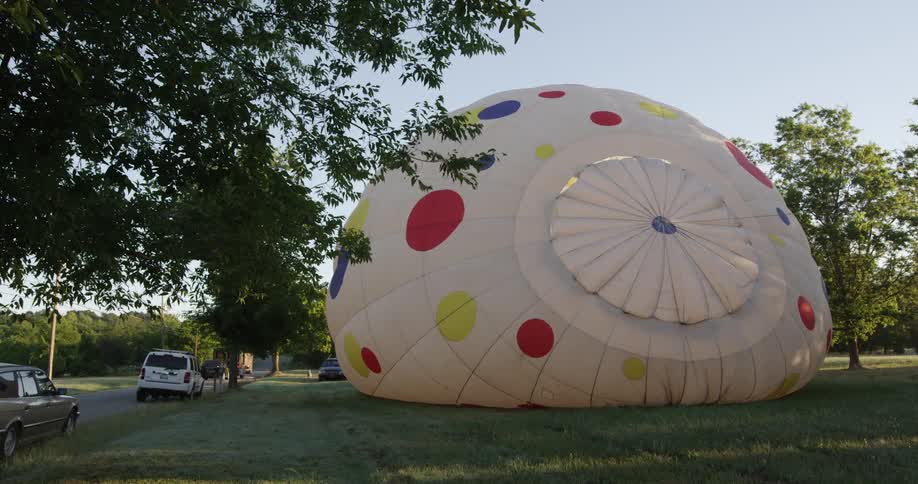 A large hot air balloon fills with air