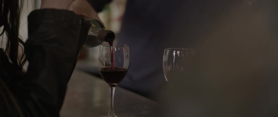 Man pours wine in a glass