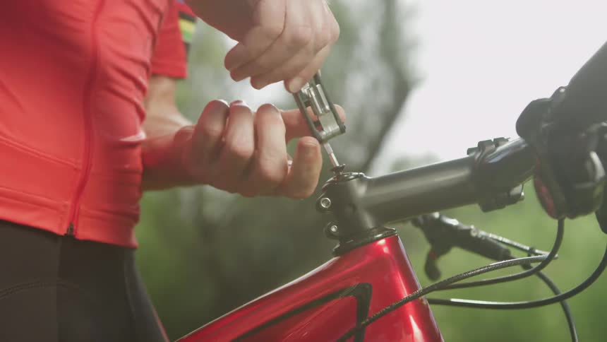 A man screwing something onto his bike