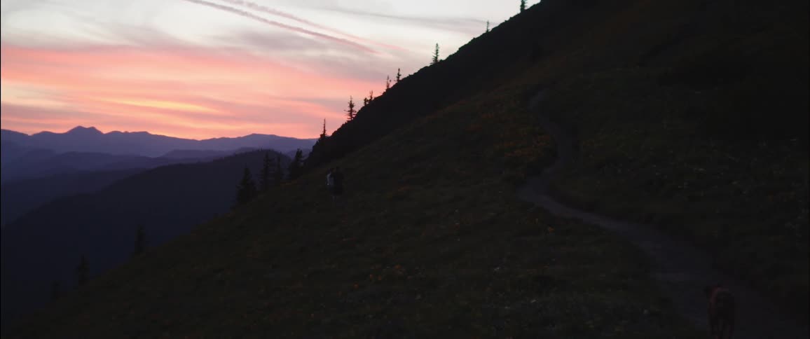 The sun is setting behind a mountain