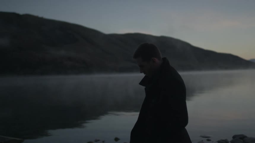 A person walking next to a lake