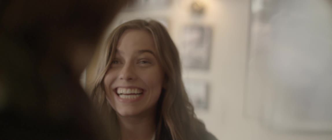 A woman talks and smiles