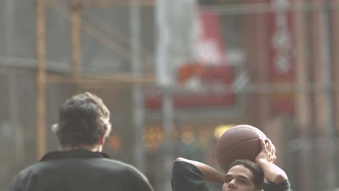 A group of man playing basketball