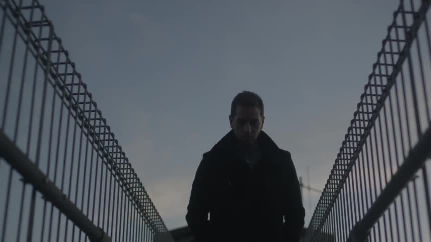Man walks in a fenced area
