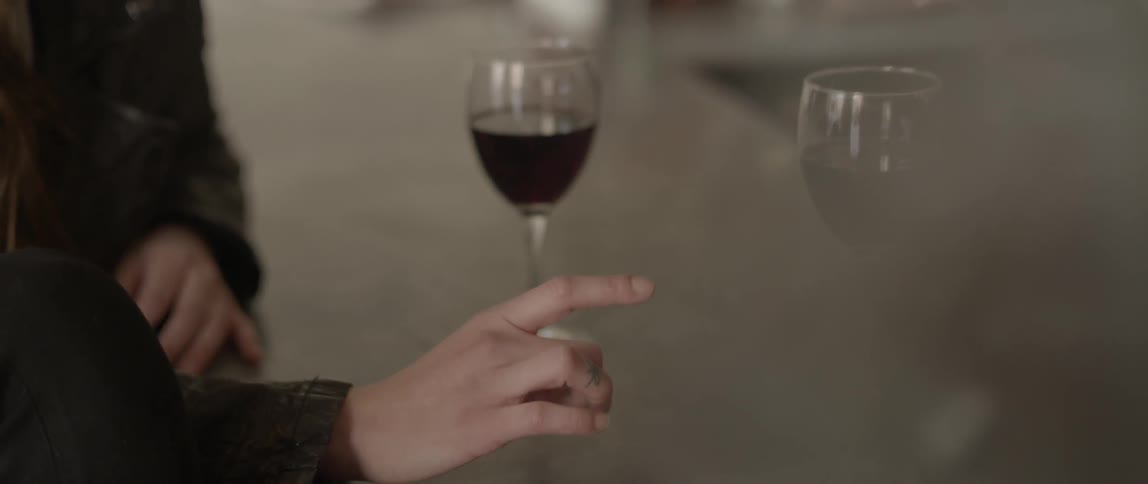 A woman drinks a glass of wine