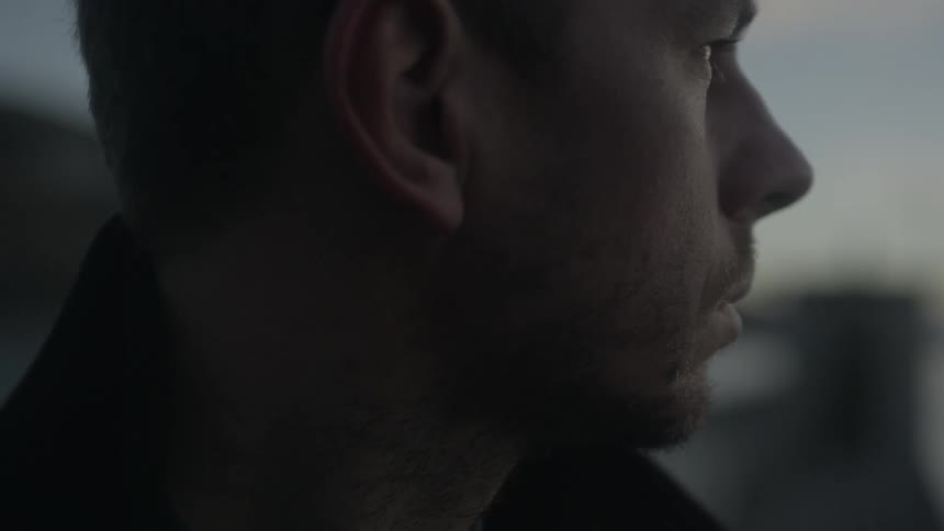 A thoughtful man stares into space