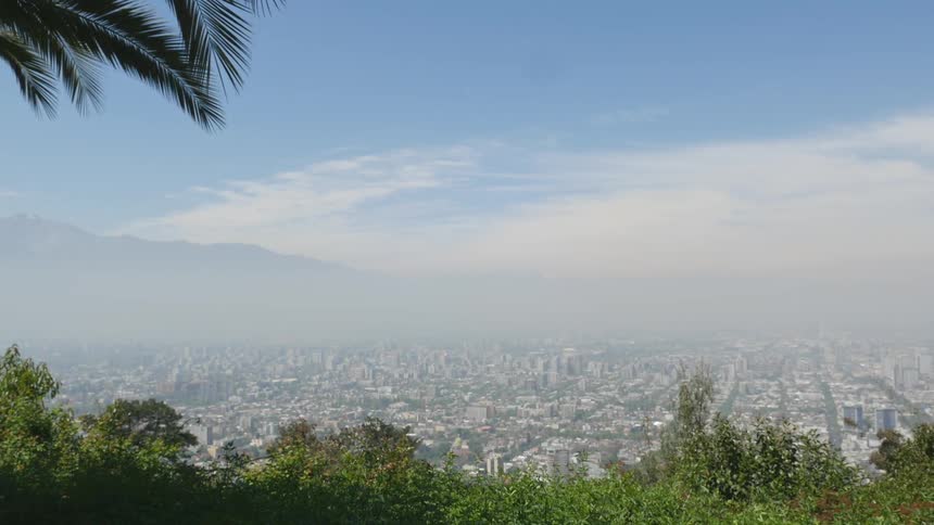 A wide angle view of a city in a valley on a windy and foggy day