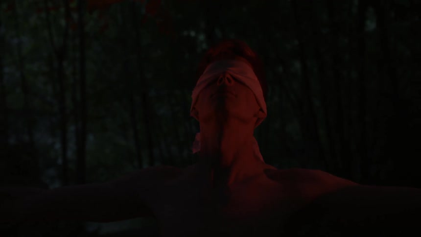 Man wearing a blindfold looks up