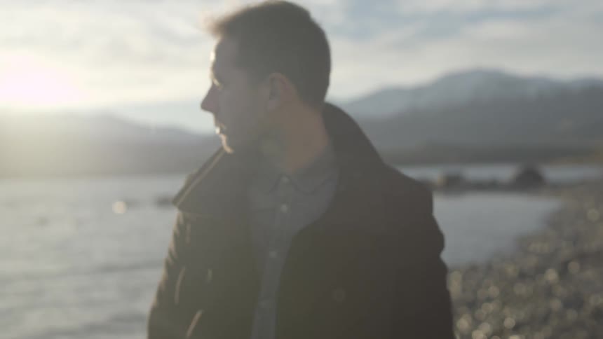 Man on beach looking at sunset