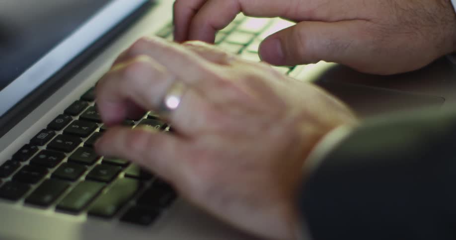 A man types on a keyboard