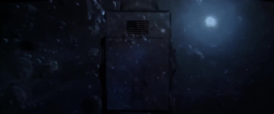 A person in a costume watching projected videos of planets in space