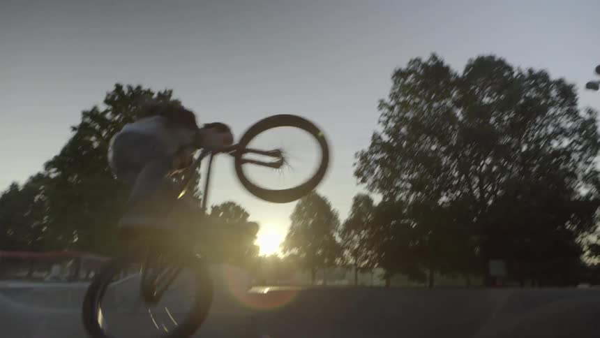 A biker doing tricks on a ramp in a park