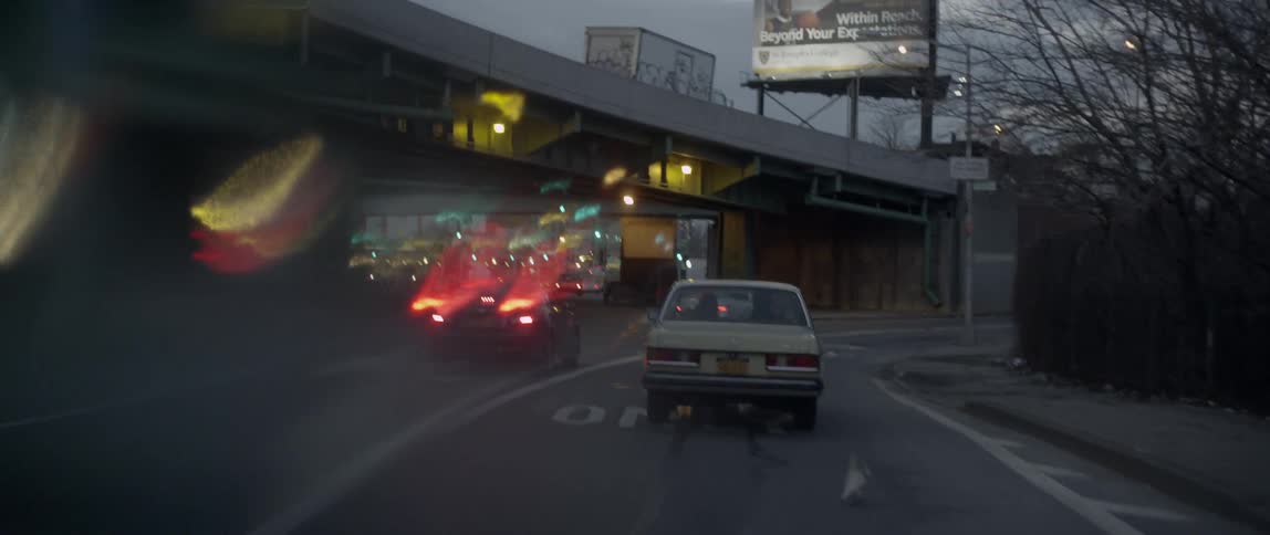 Driving down a busy road at dusk