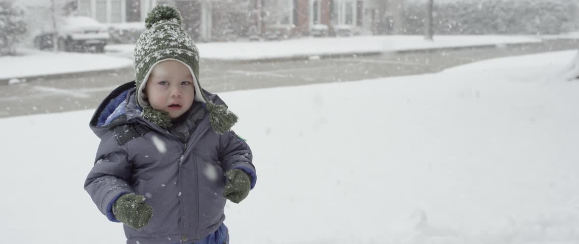 Bundled toddler plays in the snow