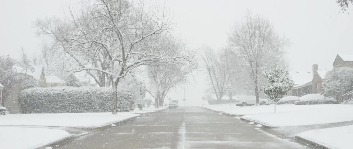 Snow falling in the suburbs