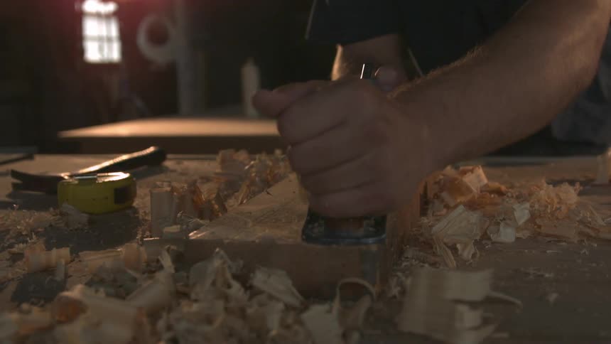 A person carving some wood