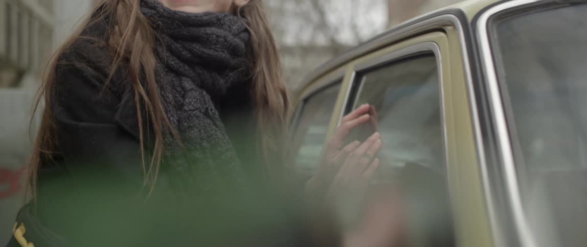 A person looking inside of a car window