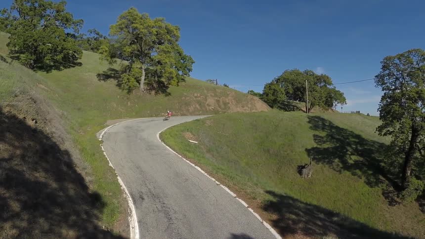 Person biking down a winding road