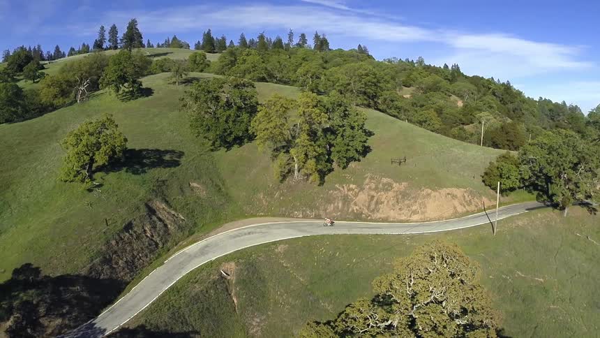 A person riding a bike on a hilltop