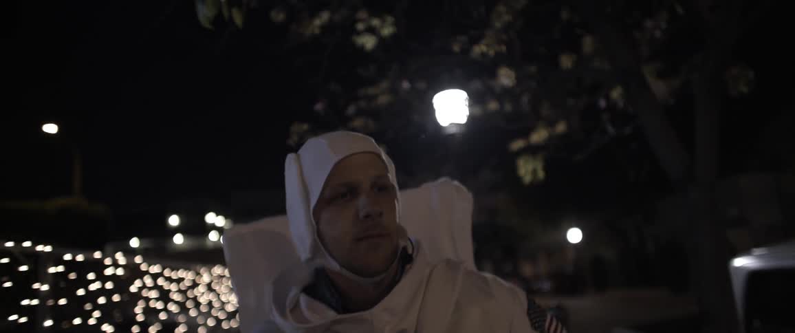 Astronaut walking outside at night