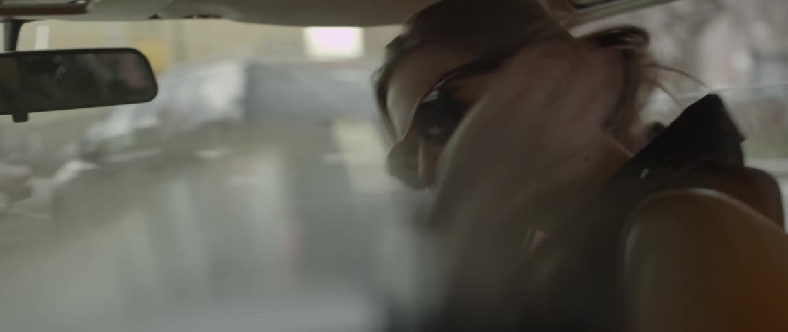A person laughing inside of a car