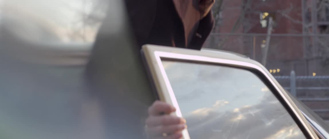 Woman opens car door for man
