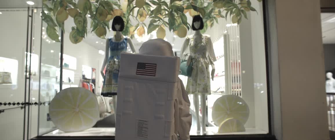 Man in spacesuit looking at a storefront display