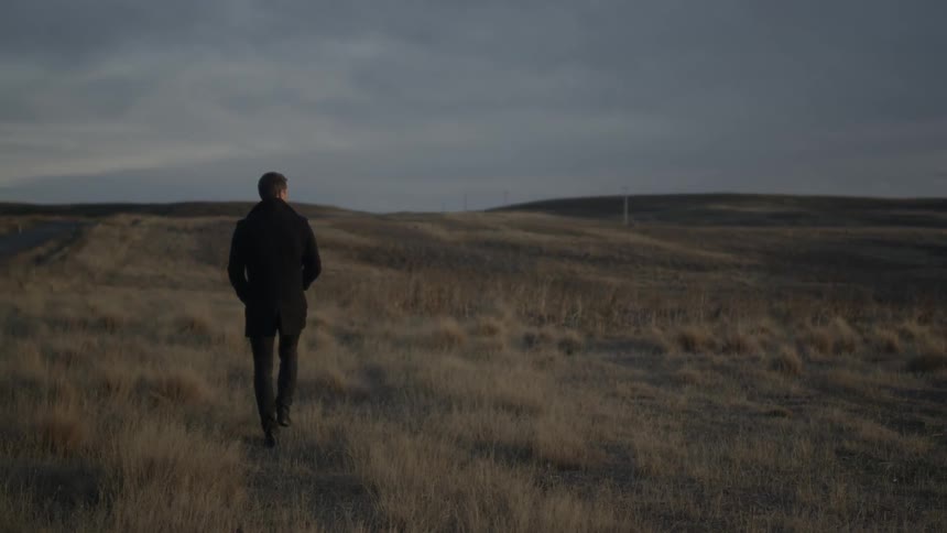 A person walking in a grassy field