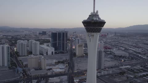 An aerial view of a high rise building and the city beneath