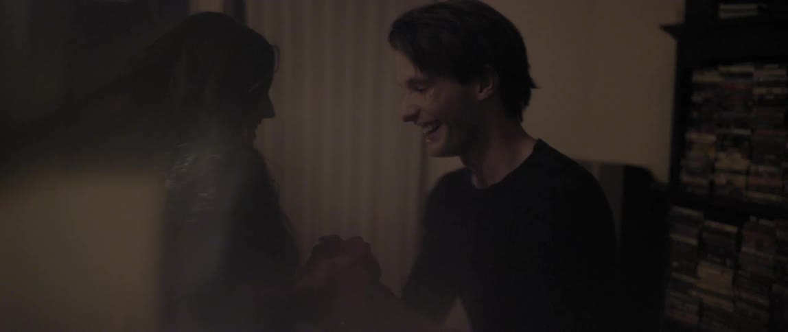 A man and woman dance and laugh