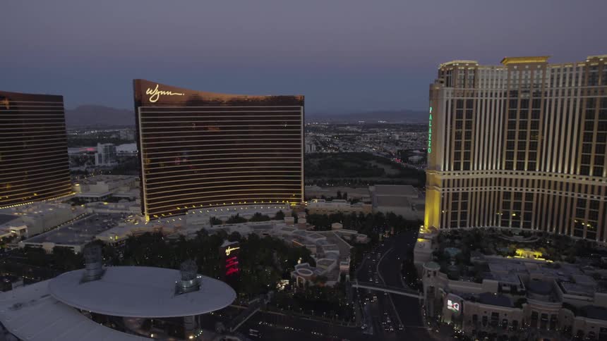 Highly lit buildings at dawn on a long strip