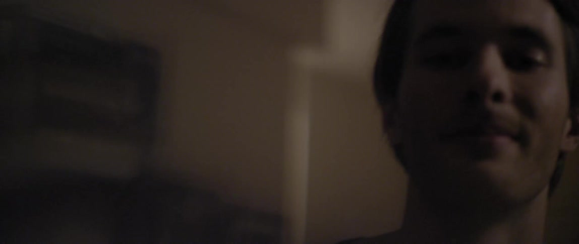 Man gleefully dancing indoors while grinning