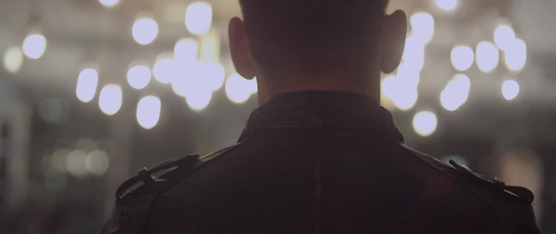 Two people in leather jackets walk