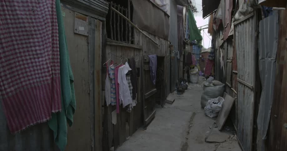 Clothes hang in a breezy alley of a slum