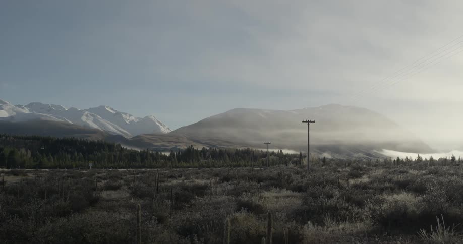 Mountains are in the distance as a slight fog rolls in