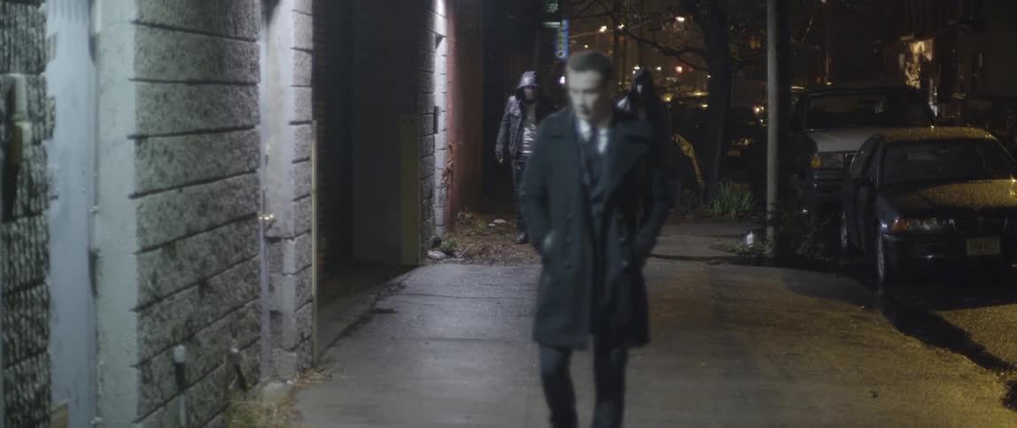 Men strolling a city street at night
