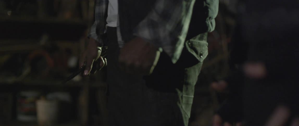 Two men standing nervously with one having a knife