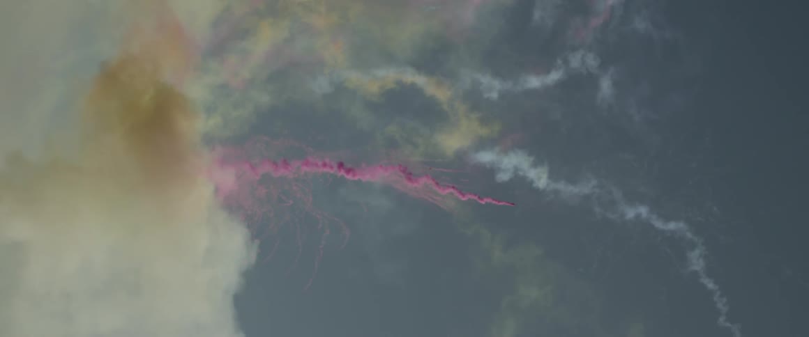 Different colored smoking racing across an open sky