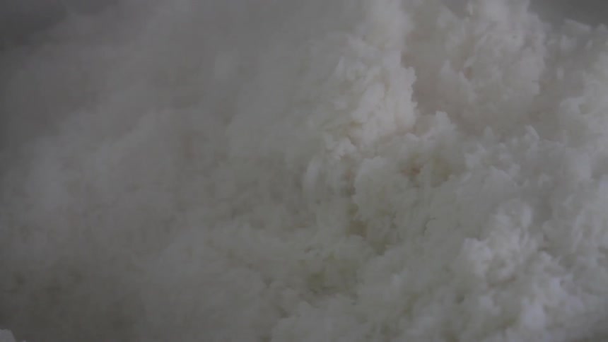 Rice being stirred in a pot
