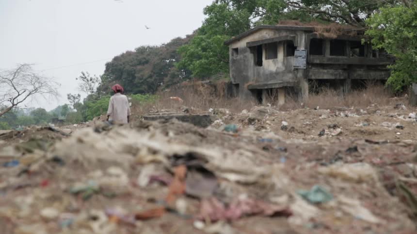 A person walks through a slum