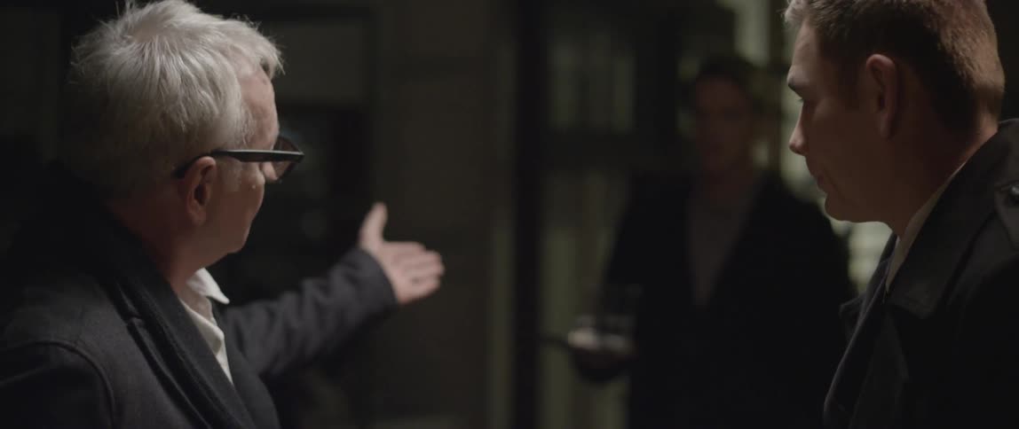 Two men have a conversation then take a shot together
