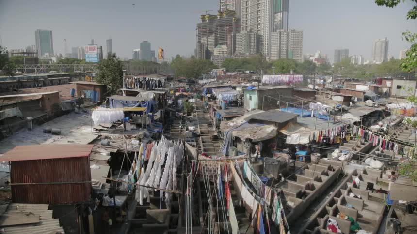 Clothes drying on lines on the outskirts of a big city