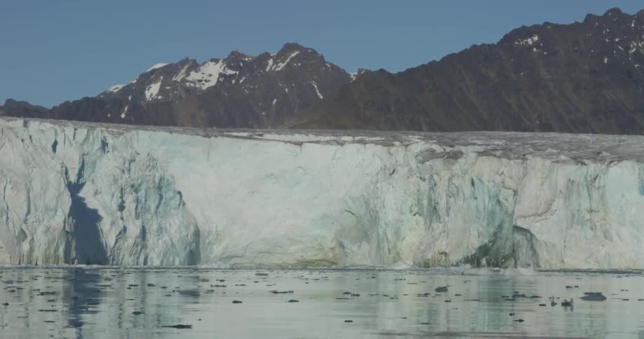 A glacier melts into the ocean