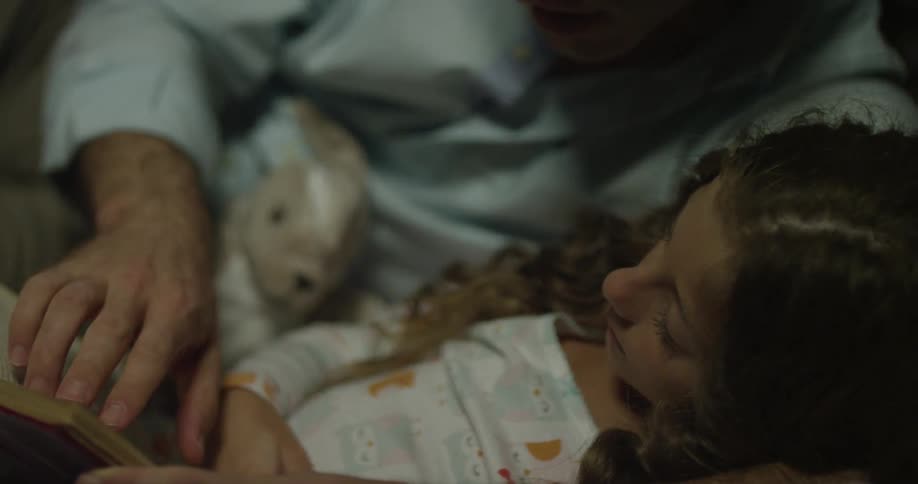 A person sitting to read with a child