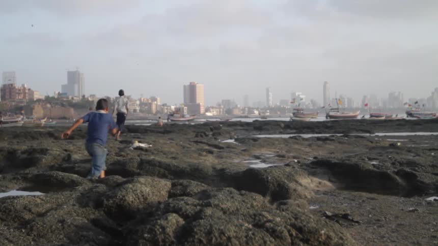 A group of kids running on mossy rocks