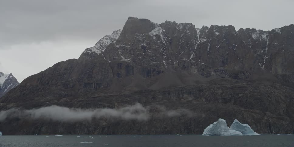 Clouds passing over floating icebergs