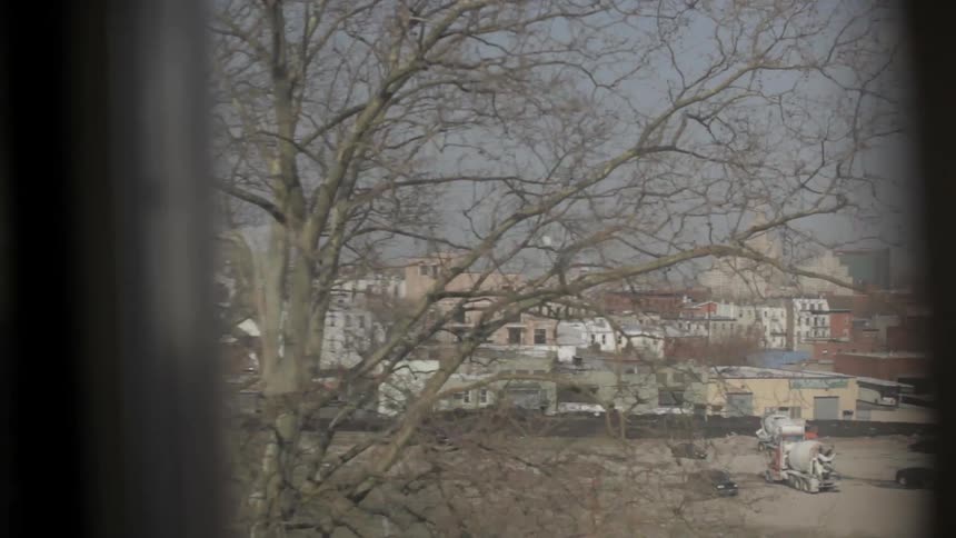 A city is seen from a train window
