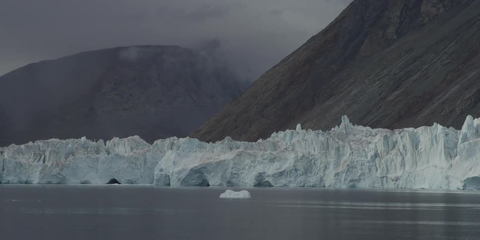 Glaciers float in front of mountains