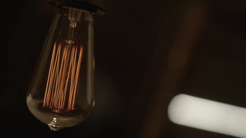 The wires in a light bulb flicker on and off